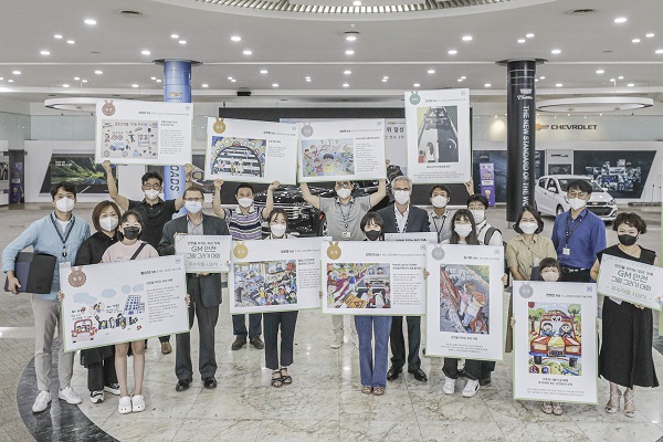 지난 12일 개최된 그림 그리기 대회 시상식에 참여한 GM 한국사업장 직원과 가족들이 그림을 들고 있다. [한국지엠 제공]